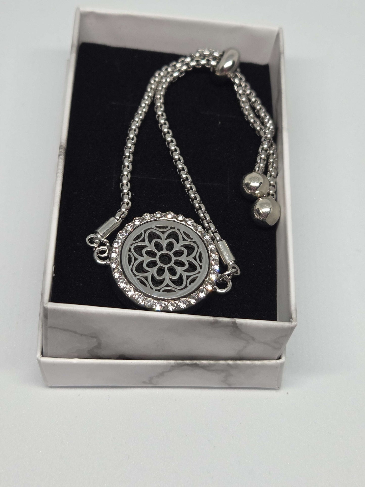Silver coloured perfume diffuser bracelet with flower head design - MAZAROMA