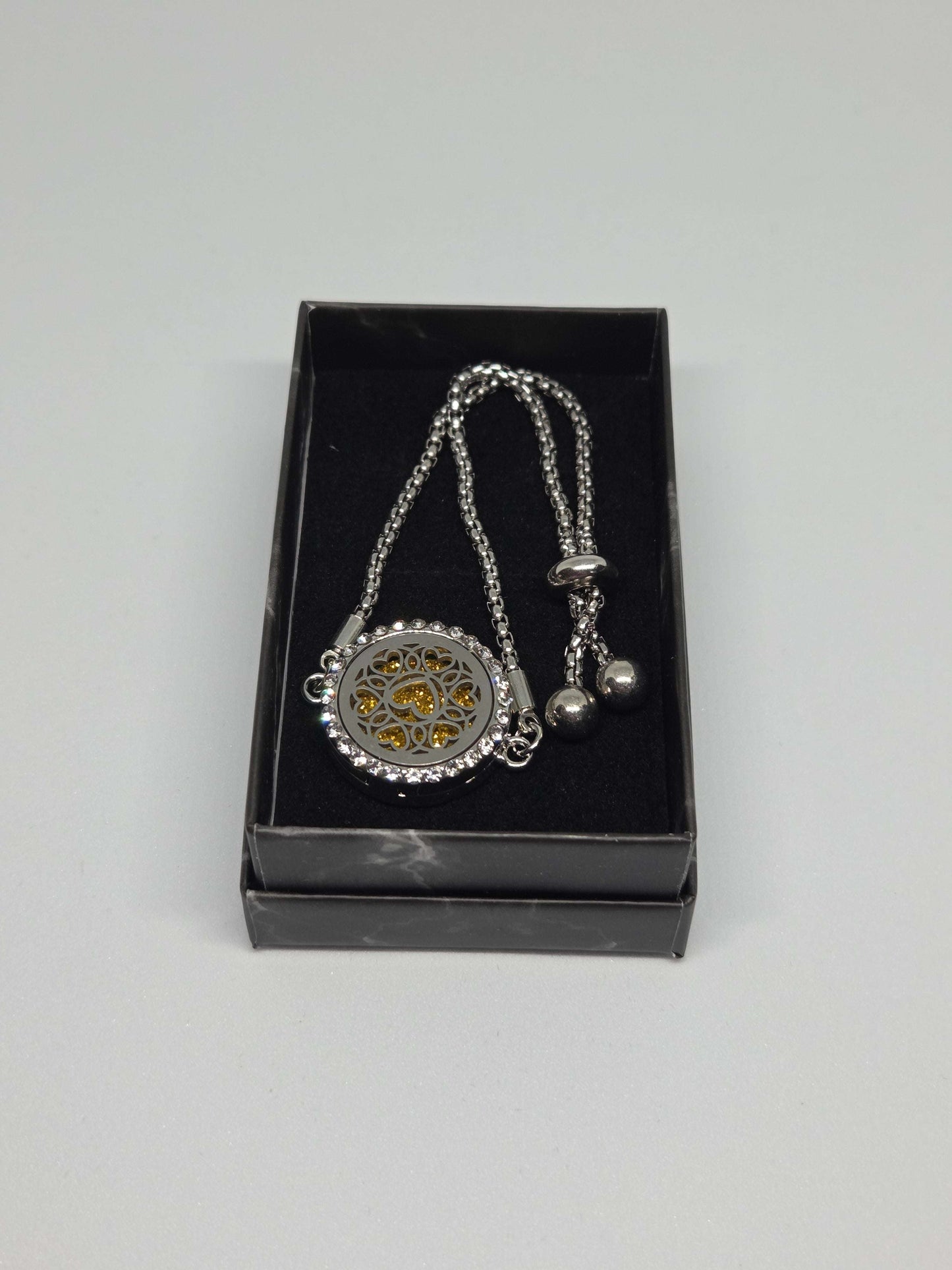 Silver coloured perfume diffuser bracelet with diamanté face in love hearts design - MAZAROMA